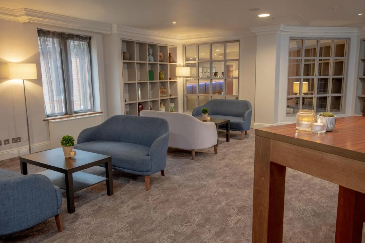 a living room with couches and chairs and a table at Cambridge Belfry Hotel & Spa in Cambourne